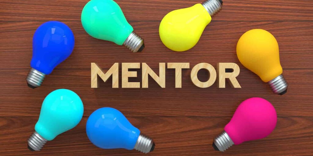 Mentor Light Bulb Concept, Colorful Light Bulb On Wooden Background