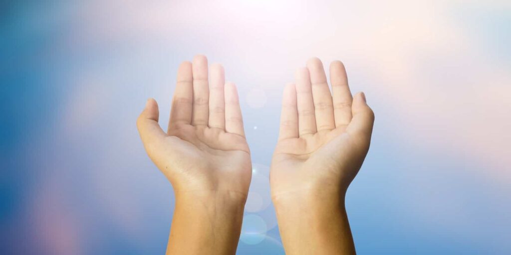 Open two hands with abstract nature background
