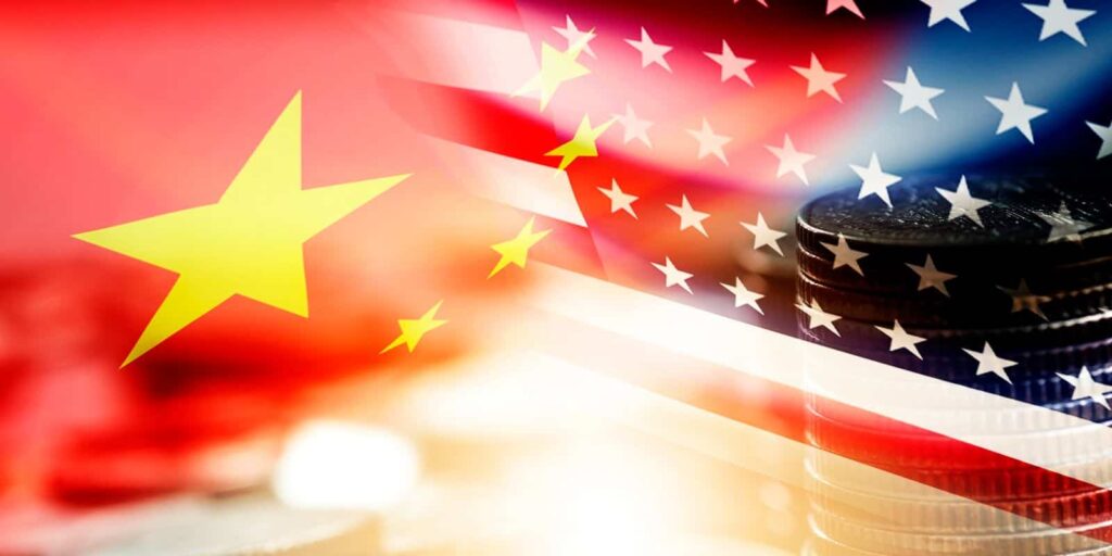USA and China flag on coins stacking .It is symbol of economic tariffs trade war and tax barrier between United States of America and China.