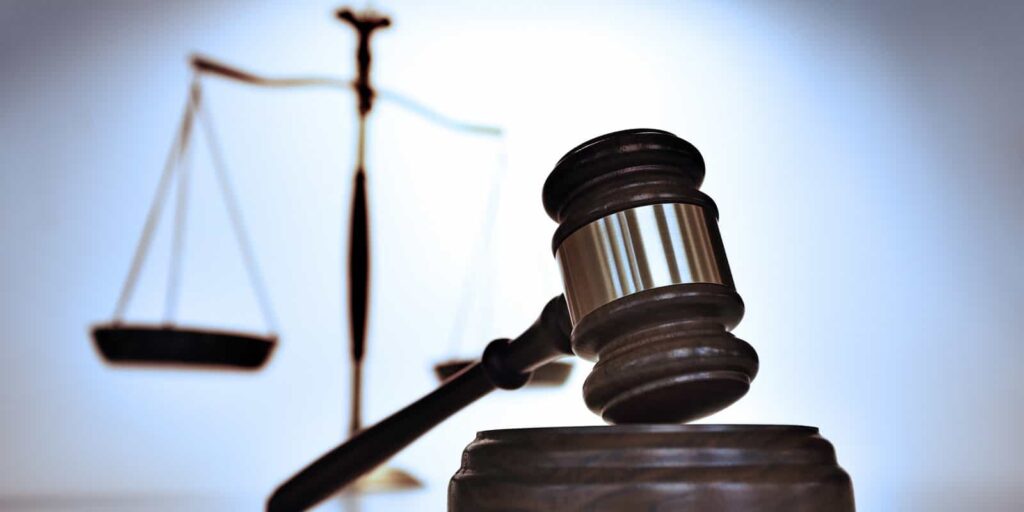 Gavel With Justice Scale In Background