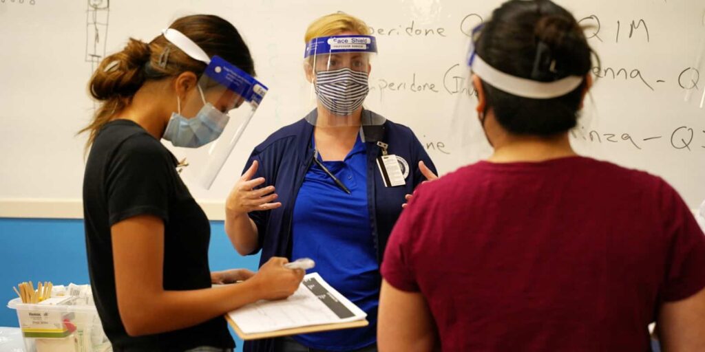 Dr. Lorin Ramocki talking with nursing and community and public health students during a simulation