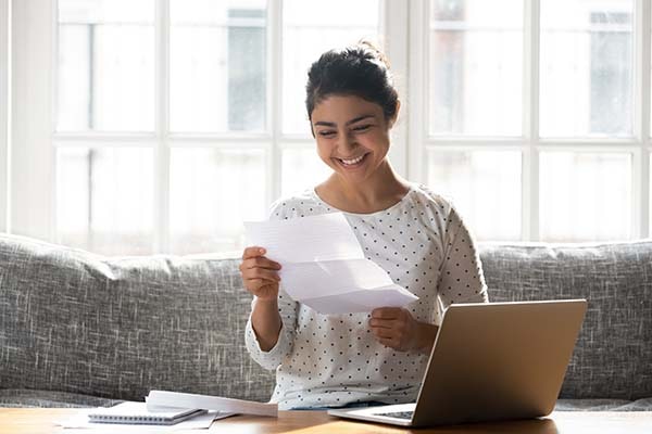 cheerful student female looking at document