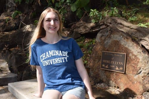 Emily Yerington, MAT '19, wearing a Chaminade shirt and smiling at camera