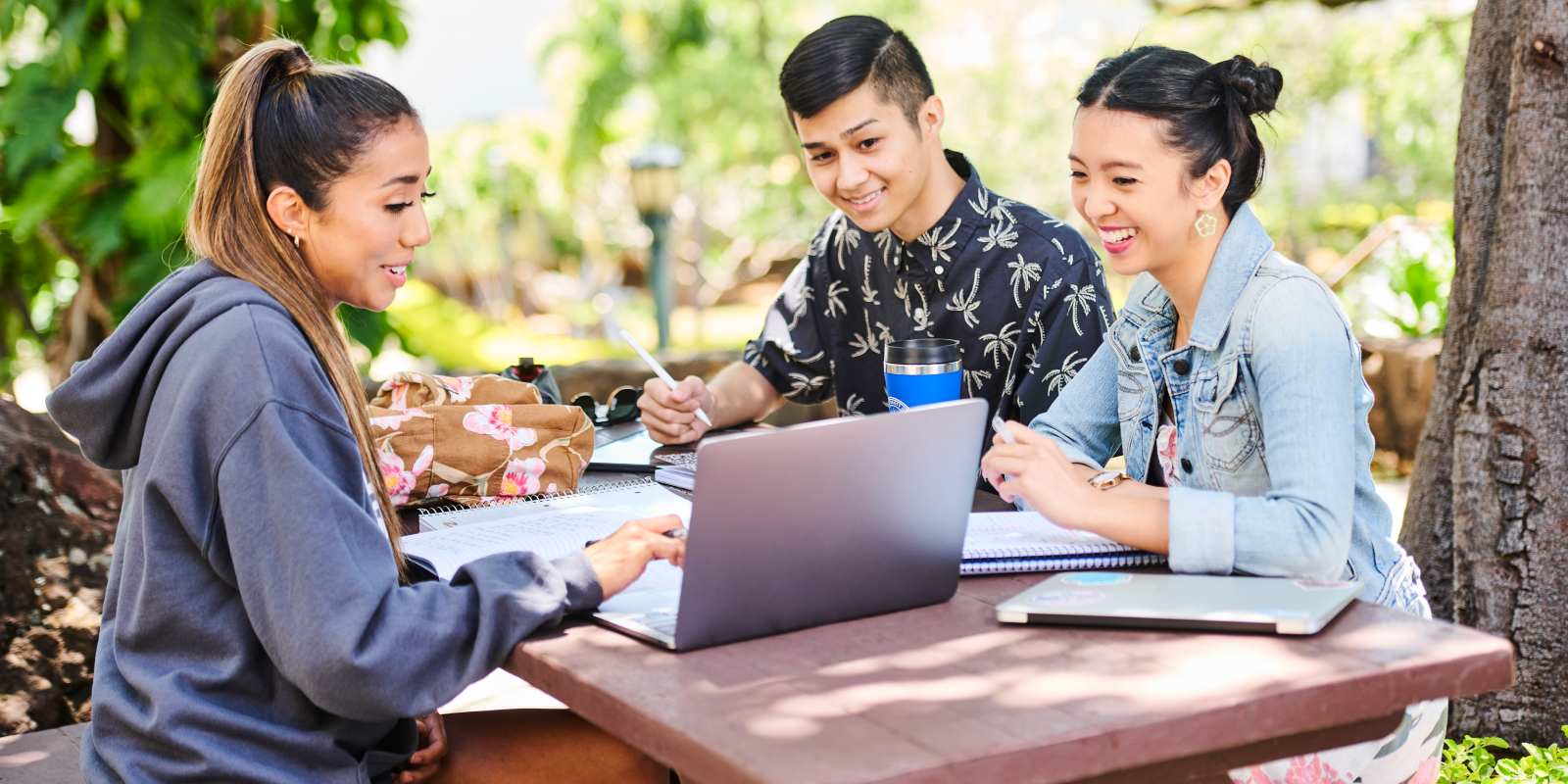 student studying together on a bench